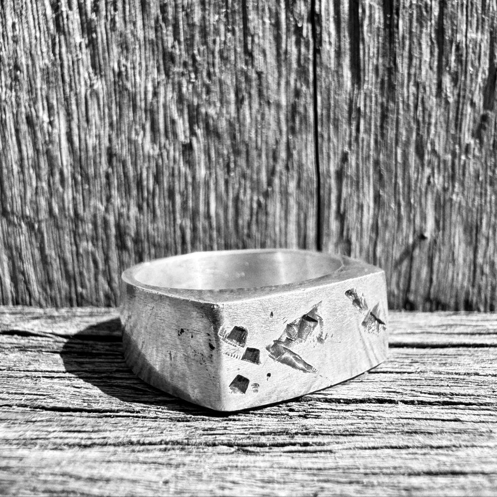 Close-up of hand-cut marks and cast texture on the Tally signet